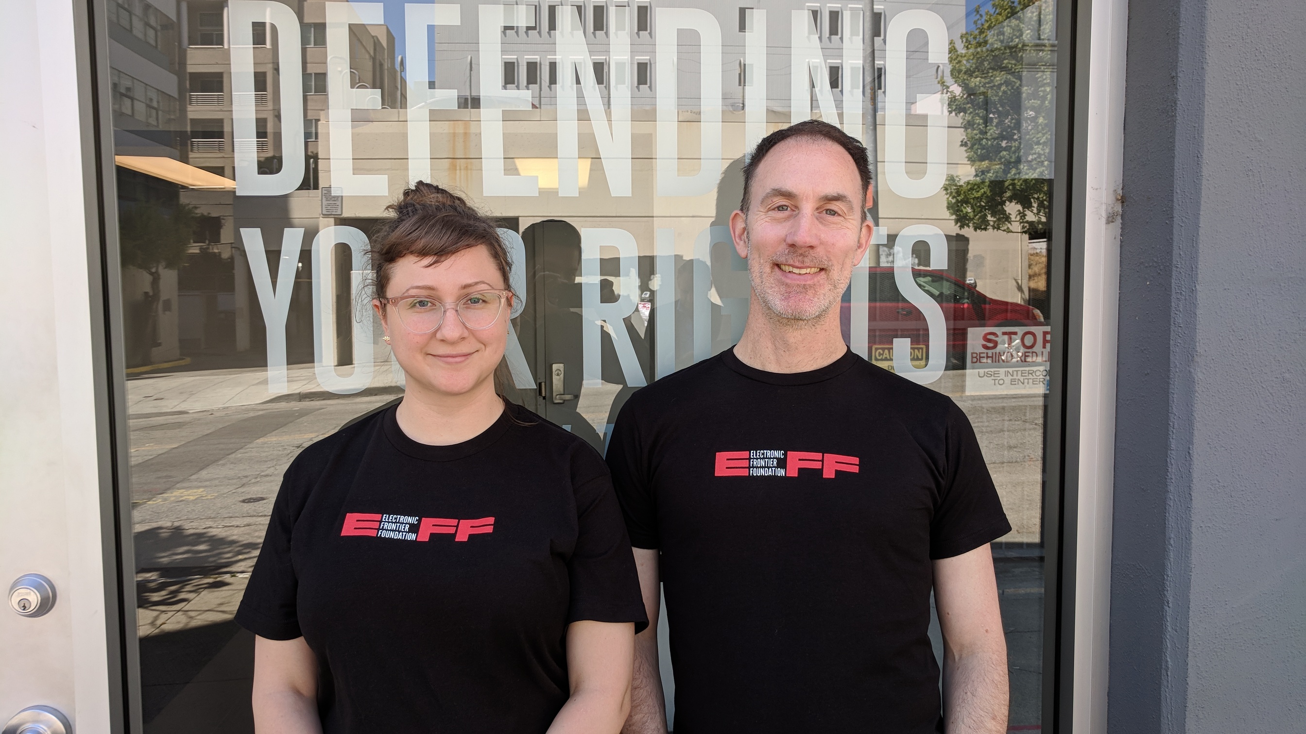 A photo of two EFF staffers wearing the new shirt.