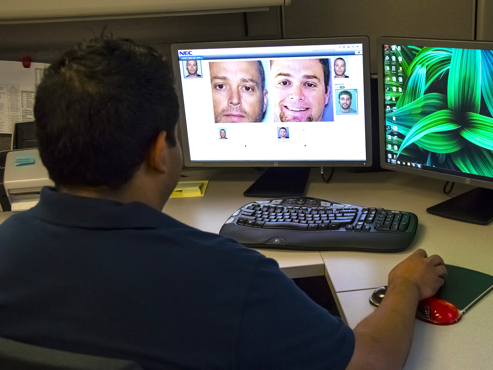 An Arizona Department of Transportation worker sits at a computer, running face recognition software.