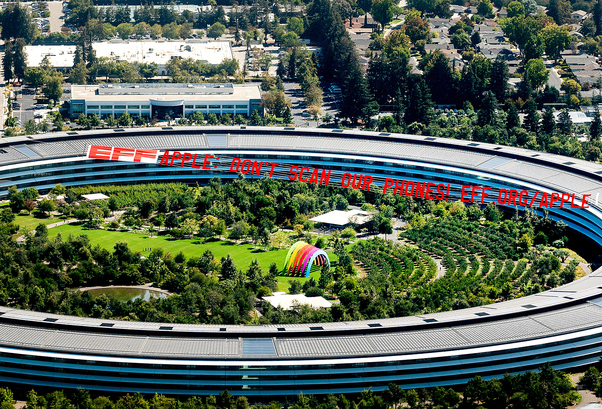 A plane flies over Apple's HQ with a banner