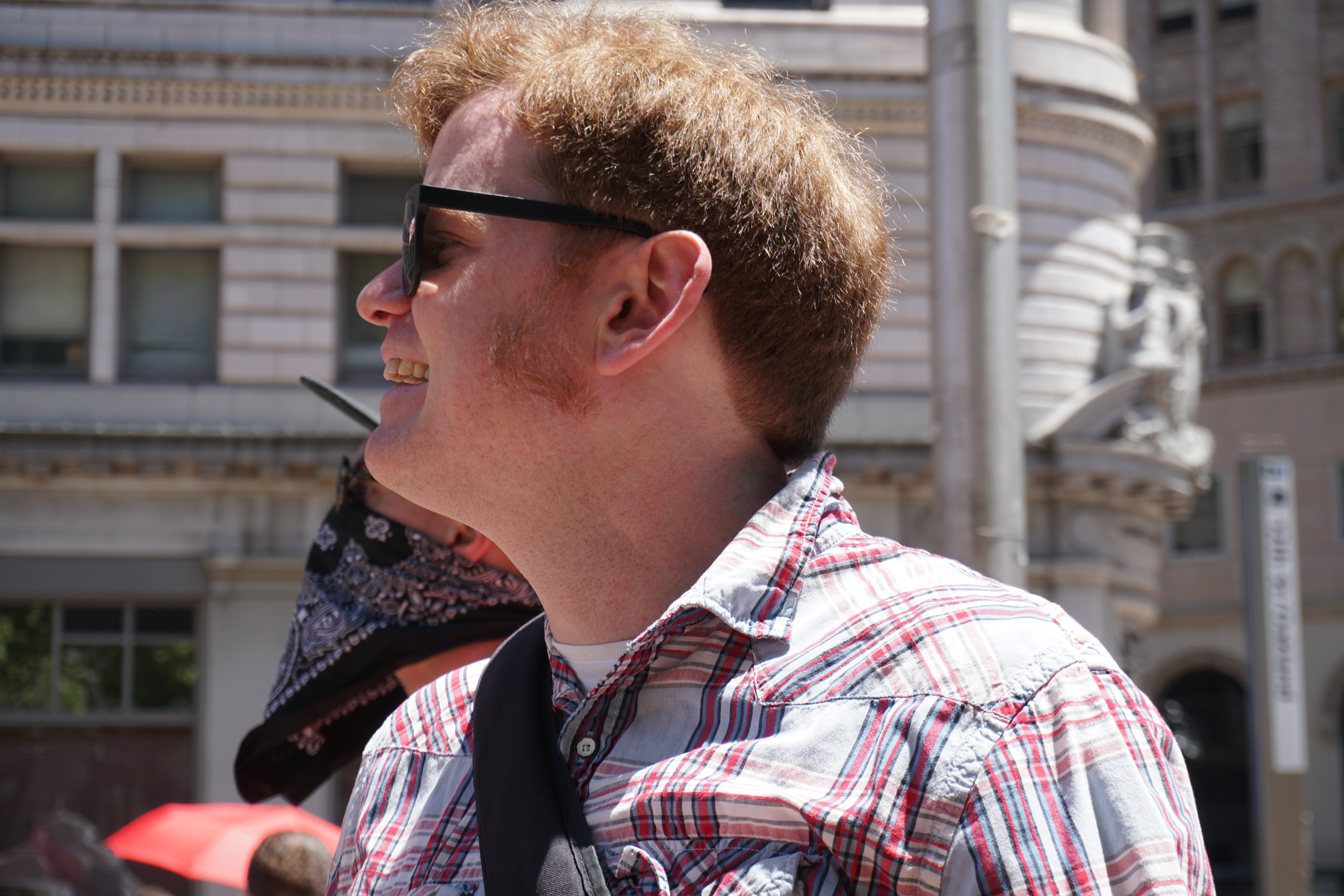 A side profile of Elliot, wearing glasses and a flannel shirt.