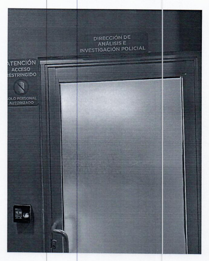 A badly photocopied image of a glass door to an office