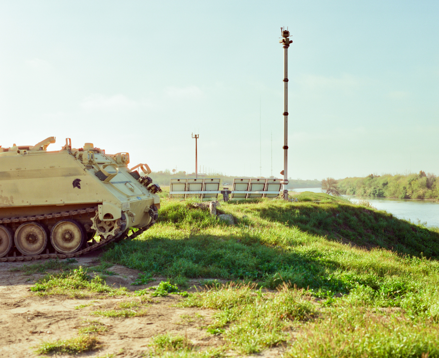 An amrored vehicle next to a surveillance tower along the Rio Grande River