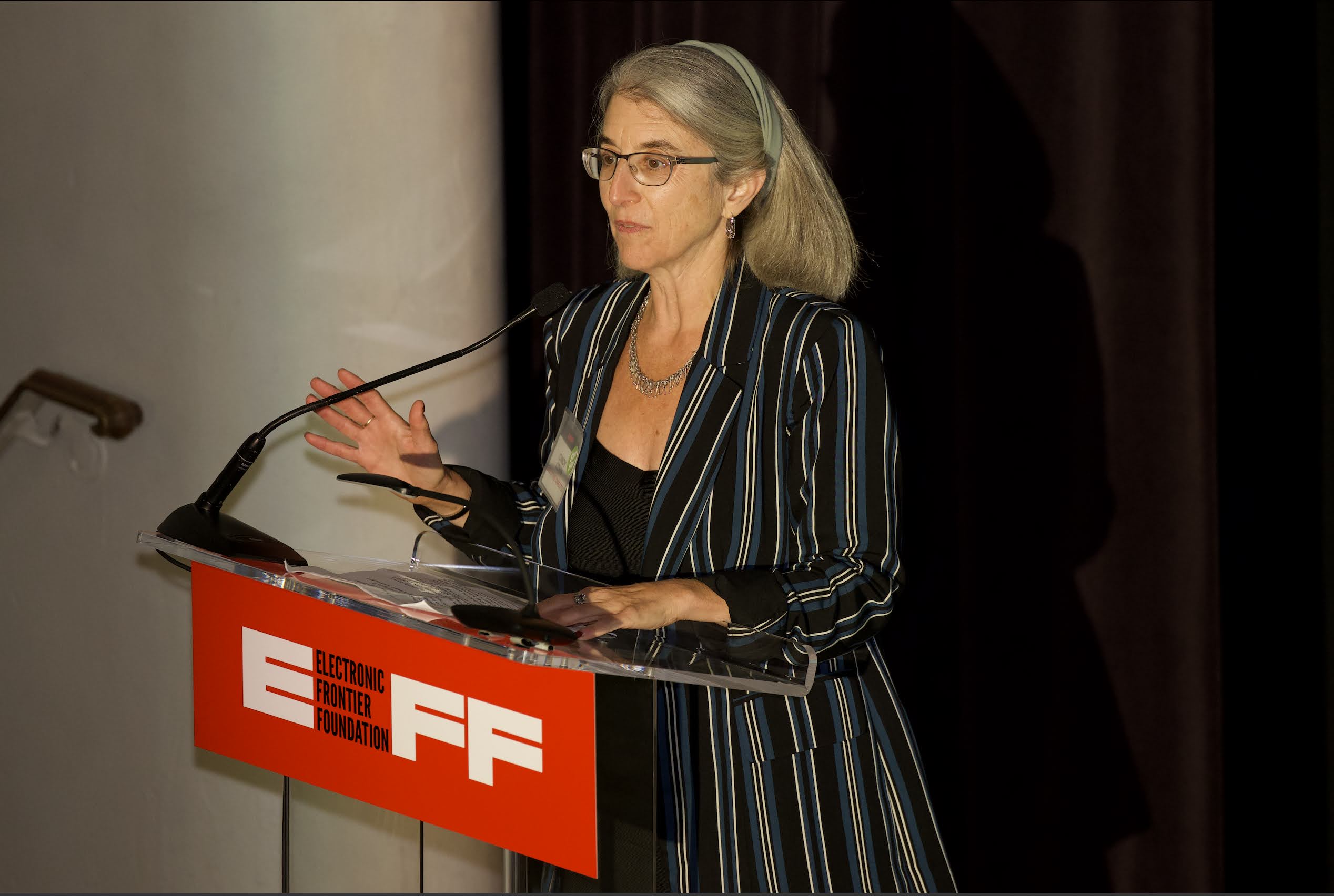 Cindy Cohn speaks from a podium.