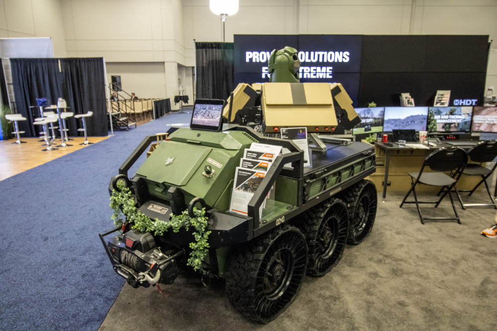 A militarized off-road vehicle in an exhibition hall. 